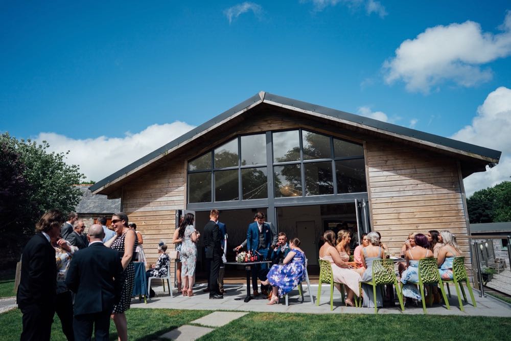 The front of the Green Room barn with guests sitting on tables outside