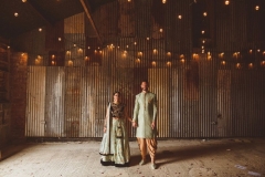 Couple in Indian wedding dress in the Really Rustic Barn