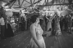 The brode gets ready to toss the bouquet in the Red Brick Barn
