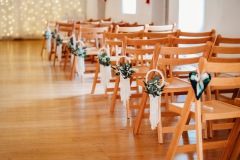 The chairs are set up in the wedding barn