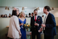 A group of guests mingle in The Green Room