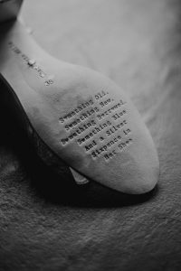 The sole of a Bride's show with the words : Something Old, Something New, Something Borrowed, Something Blue, And a Silver Sixpence in Her Shoe