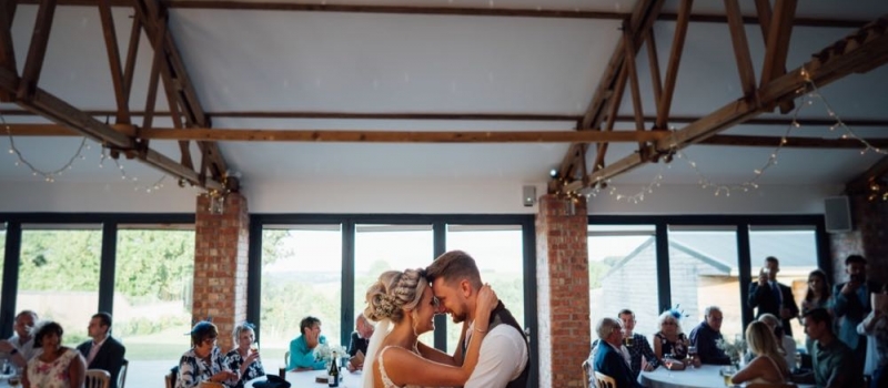 Couple have first dance in the Red Brick Barn
